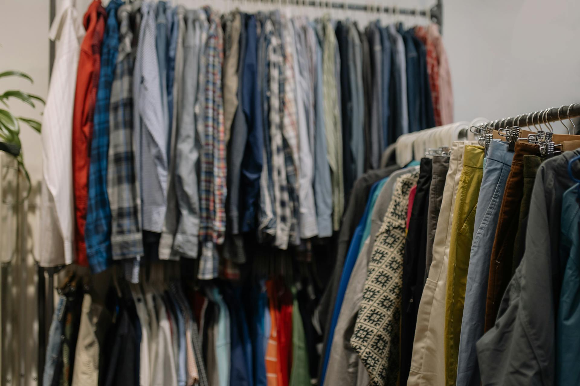 Packed clothing racks and dense retail inventory representing overconsumption